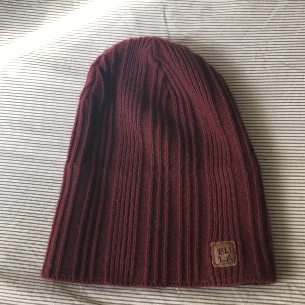 A maroon beanie and and dark green beanie